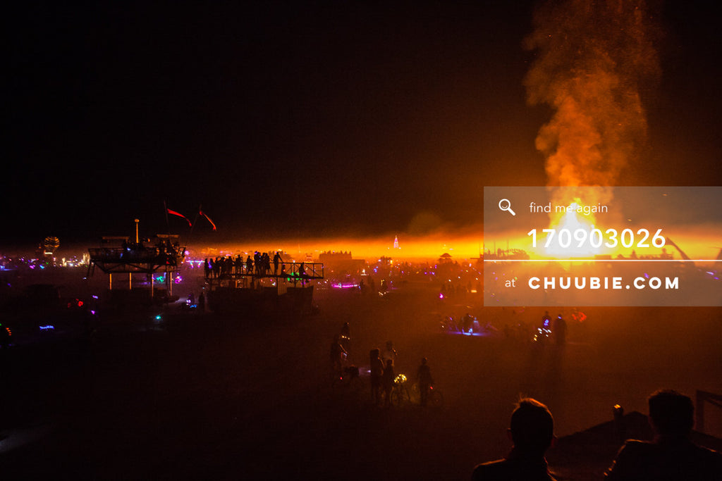 170903026 | 
Post-apocalyptic landscape of burners and art cars silhouetted by the Temple Burn, photographed ... | Team Chuubie