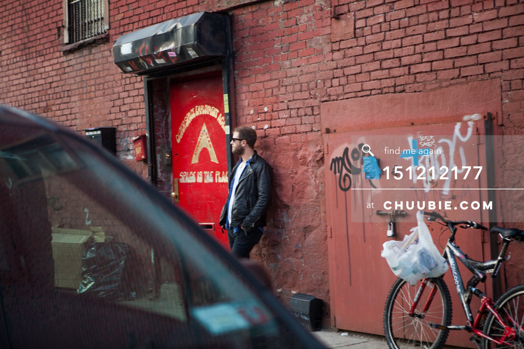 151212177 | 
After the party: Brooklyn street scenes. Man waits by red door for the Outerspace Employment Age... | Team Chuubie