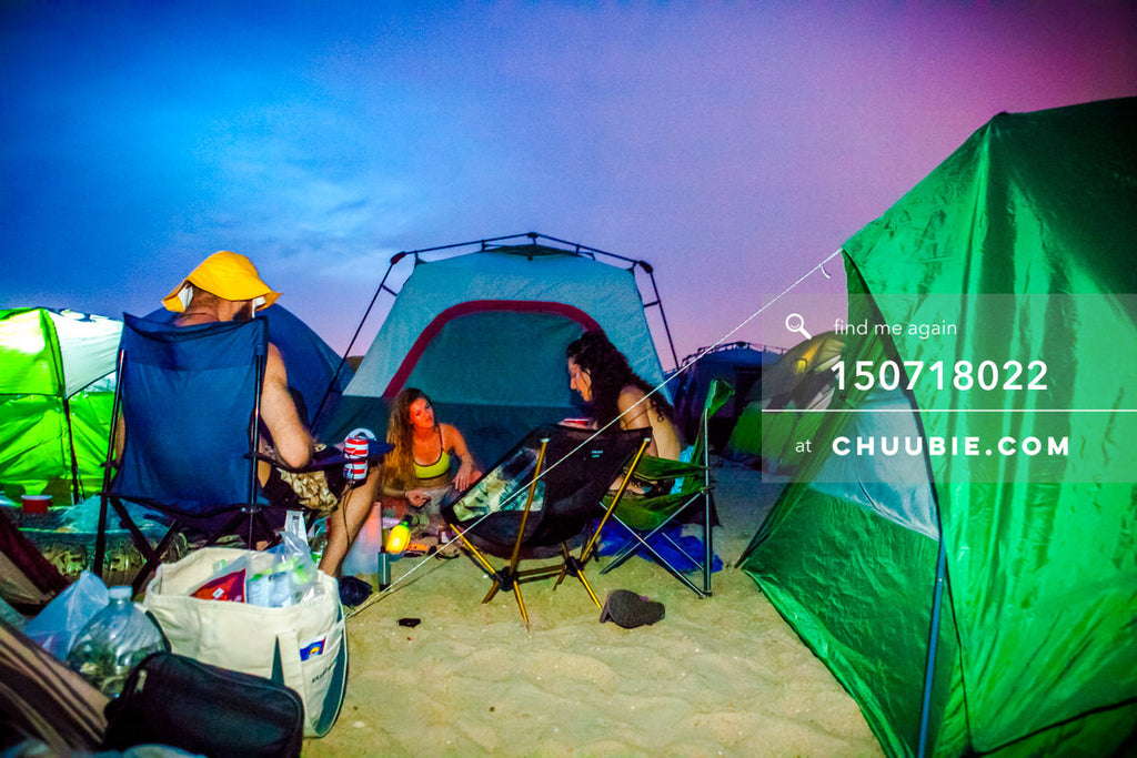 150718022 | 
Campers settle in with magnificent vibrant saturated blue-magenta sunset at regional Burning Man... | Team Chuubie