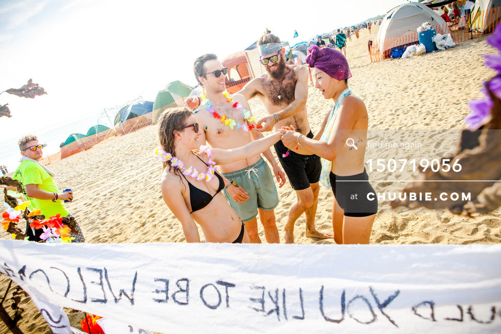 150719056 | 
Artist Poppy provides welcoming experience on the beach playa.
—Gratitude Migration 2015: Summer... | Team Chuubie