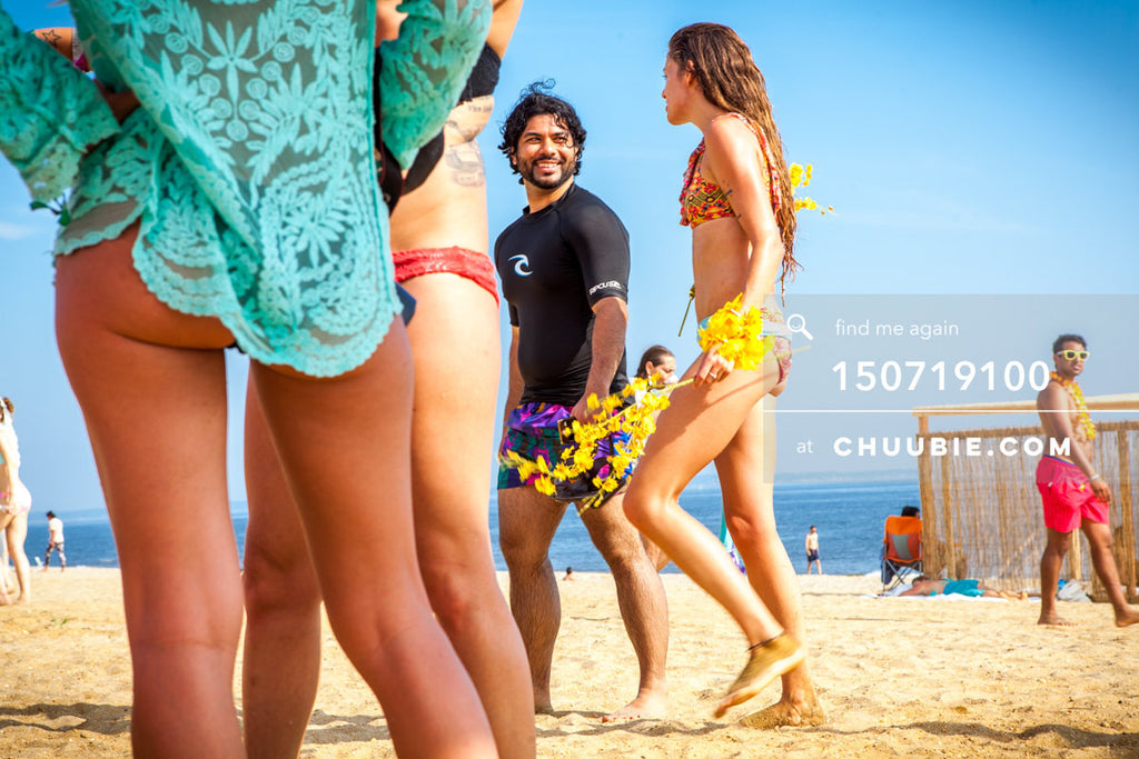 150719100 | 
Smiling surfers guy and girl, Alain Baburam & Rachel Precious, walk on summer beach.
—Gratit... | Team Chuubie