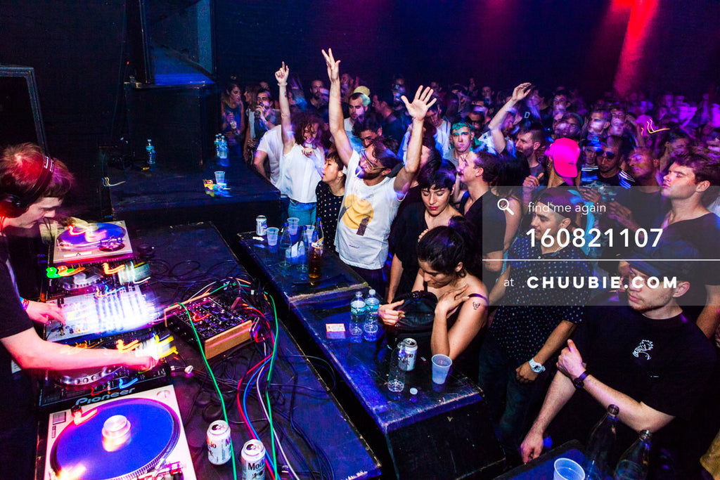 160821107 | 
Side view: Ben UFO (Ben Thomson) DJing with packed crowd dancing arms up in the air.
Electric Mi... | Team Chuubie