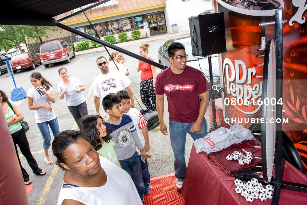 80613004 | 
Local Chicago residents spin the prize wheel

—Dr. Pepper Sabrosura mobile tour event photograph... | Team Chuubie