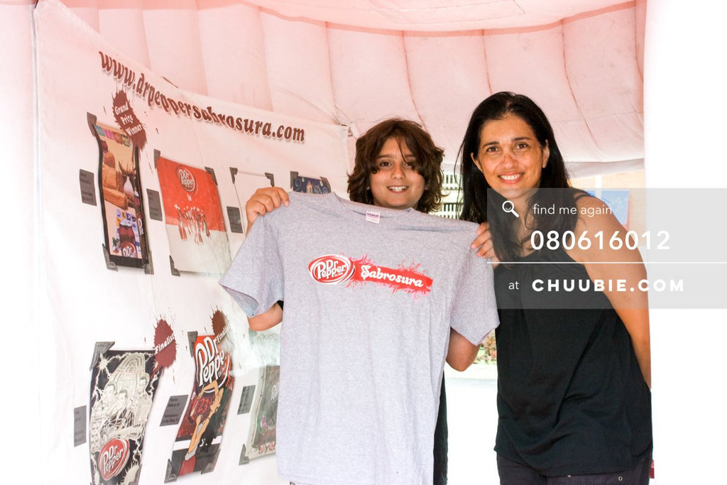 80613012 | 
Mother with son holding his Sabrosura t-shirt!

—Dr. Pepper Sabrosura mobile tour event photogra... | Team Chuubie