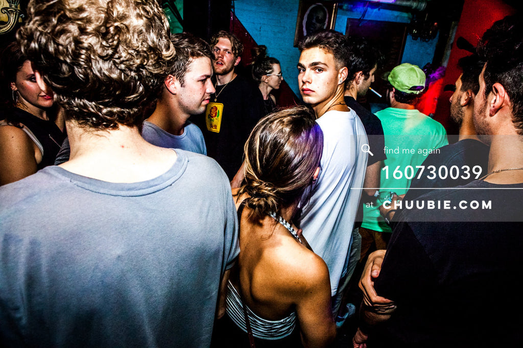 160730039 | Young guy looks back at camera in crowd at Brooklyn warehouse rave.
— Sublimate & Ruse Labs p... | Team Chuubie